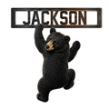 Custom bear metal sign featuring a detailed black bear climbing beneath a rustic framed design