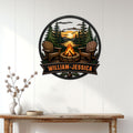 Camping wall decor displayed above a console table, featuring Adirondack chairs around a fire pit by a forest lake