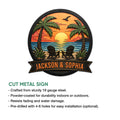 Beach house metal sign shown with a tropical sunset, palm trees, ocean waves, and Adirondack chairs
