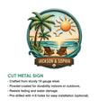 Tropical coastal metal sign featuring a beach sunset, palm trees, ocean waves, and a decorative shell accent