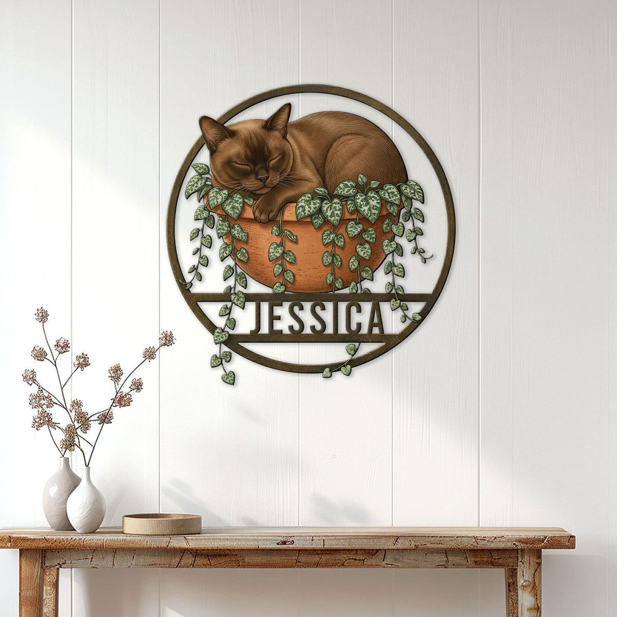 Burmese cat wall sign displayed above a console table in a bright, modern home