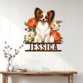 Papillon dog wall sign displayed on a light wood-paneled wall above a console table