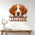 Brittany Spaniel wall sign displayed on a light paneled wall above a rustic console table