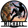 Rock climbing metal sign with a climber silhouette scaling a scenic cliff at sunset