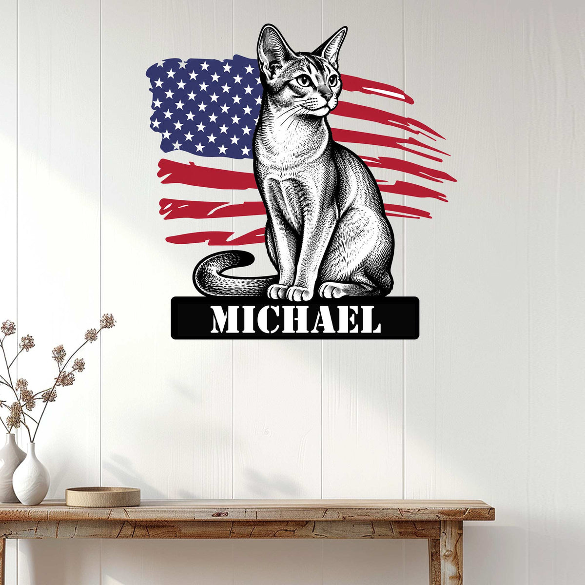 Patriotic Abyssinian cat wall sign displayed on a white wood-paneled wall above a console table