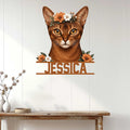 Abyssinian cat wall sign displayed on a light wood-paneled wall above a console table