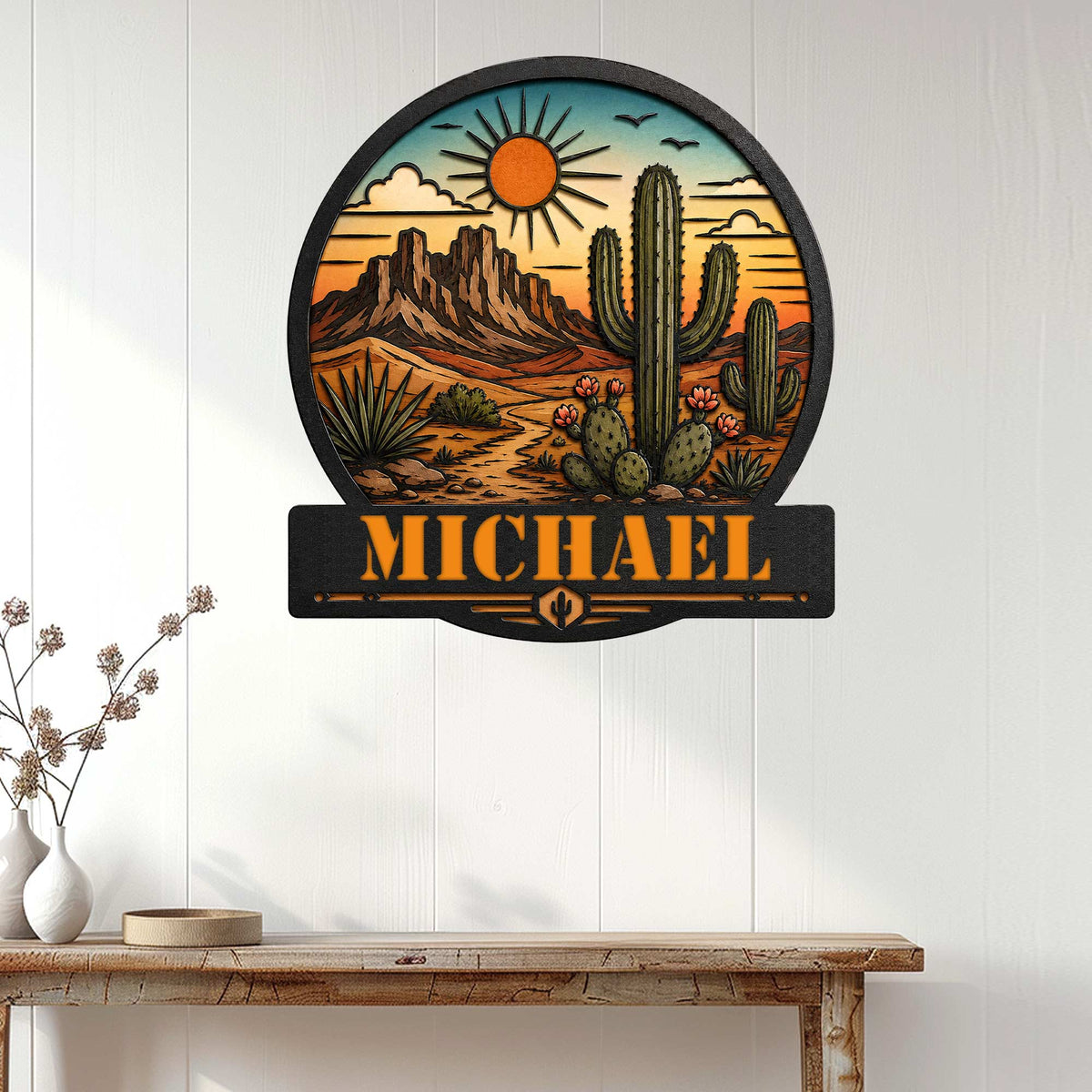 Cactus desert wall sign displayed on a white paneled wall above a rustic console table