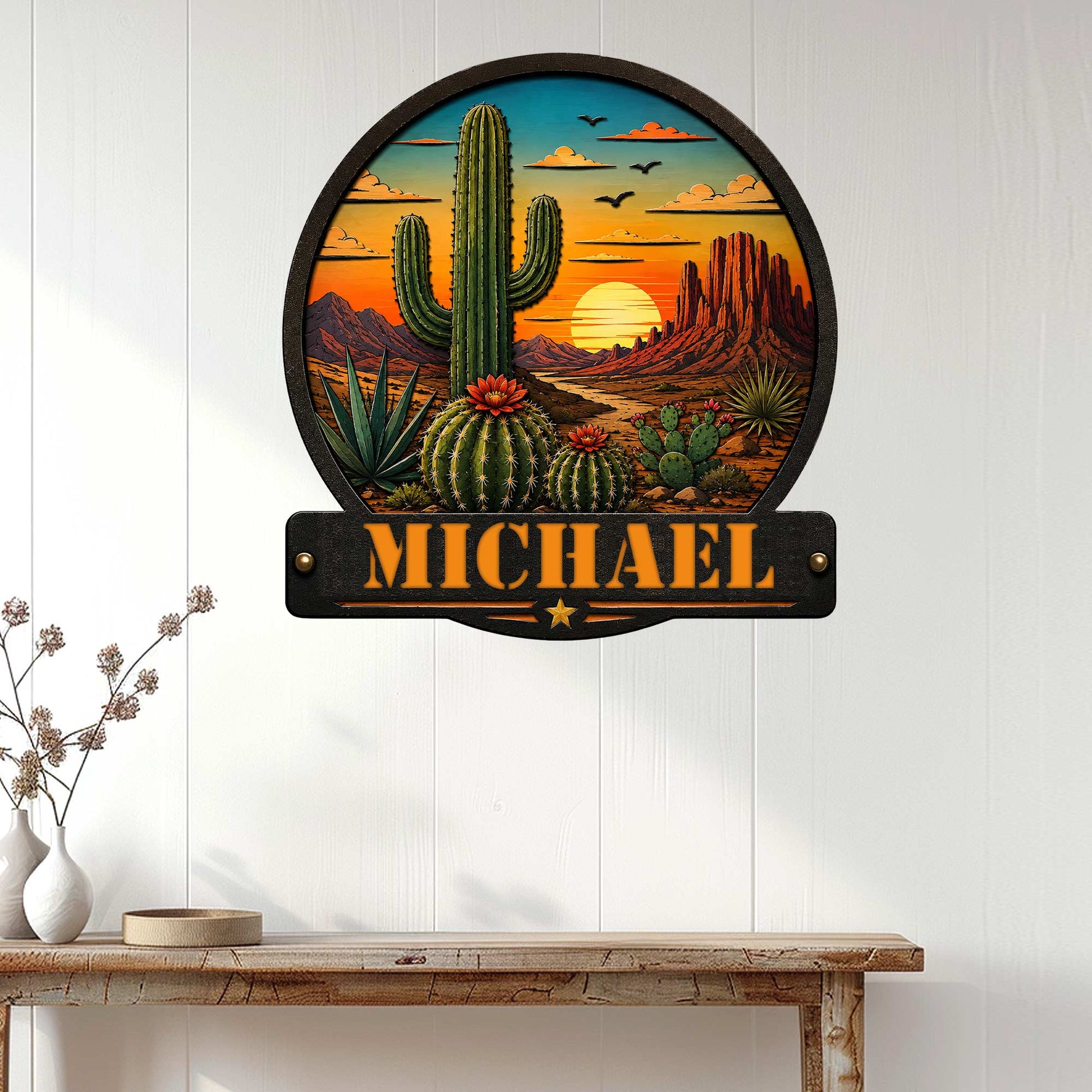 Cactus sunset metal wall sign displayed on a white paneled wall above a rustic console table