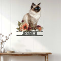 Floral Birman cat metal sign displayed on a light paneled wall above a console table