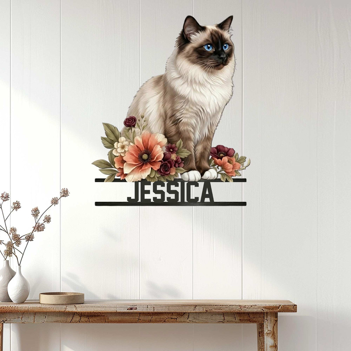 Floral Birman cat metal sign displayed on a light paneled wall above a console table