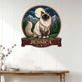 Birman cat wall sign displayed on a light paneled wall above a console table