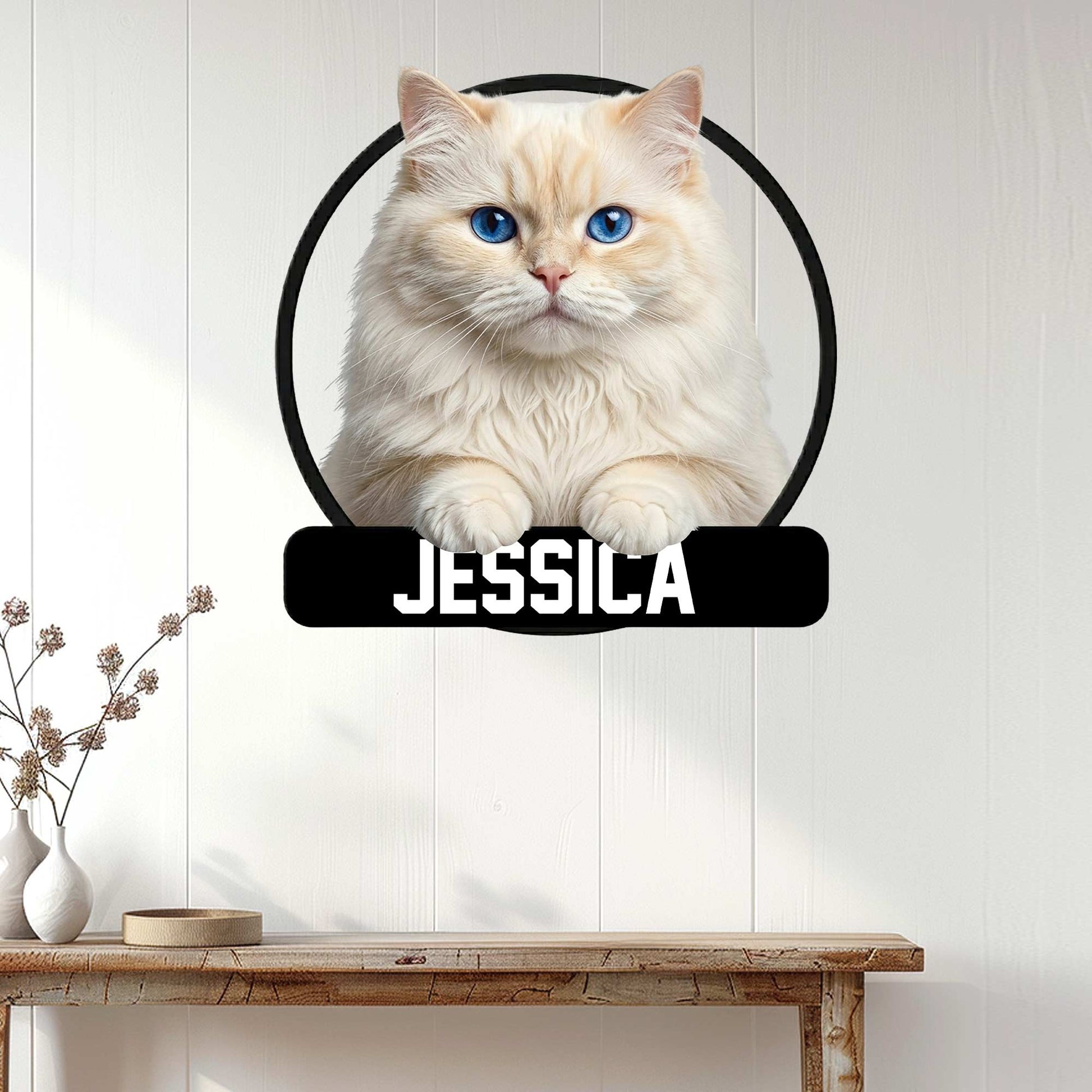 Persian cat metal wall sign displayed on a light wood-paneled wall above a console table