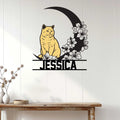 British Shorthair cat metal wall sign displayed on a light wood-paneled wall above a console table