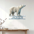 Polar bear wall sign displayed against white wood paneling in a bright home interior