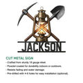Coal mining cut metal sign showcasing a lantern, pickaxe, and shovel design