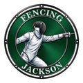Round fencing metal sign featuring a masked fencer in action against a rich green background