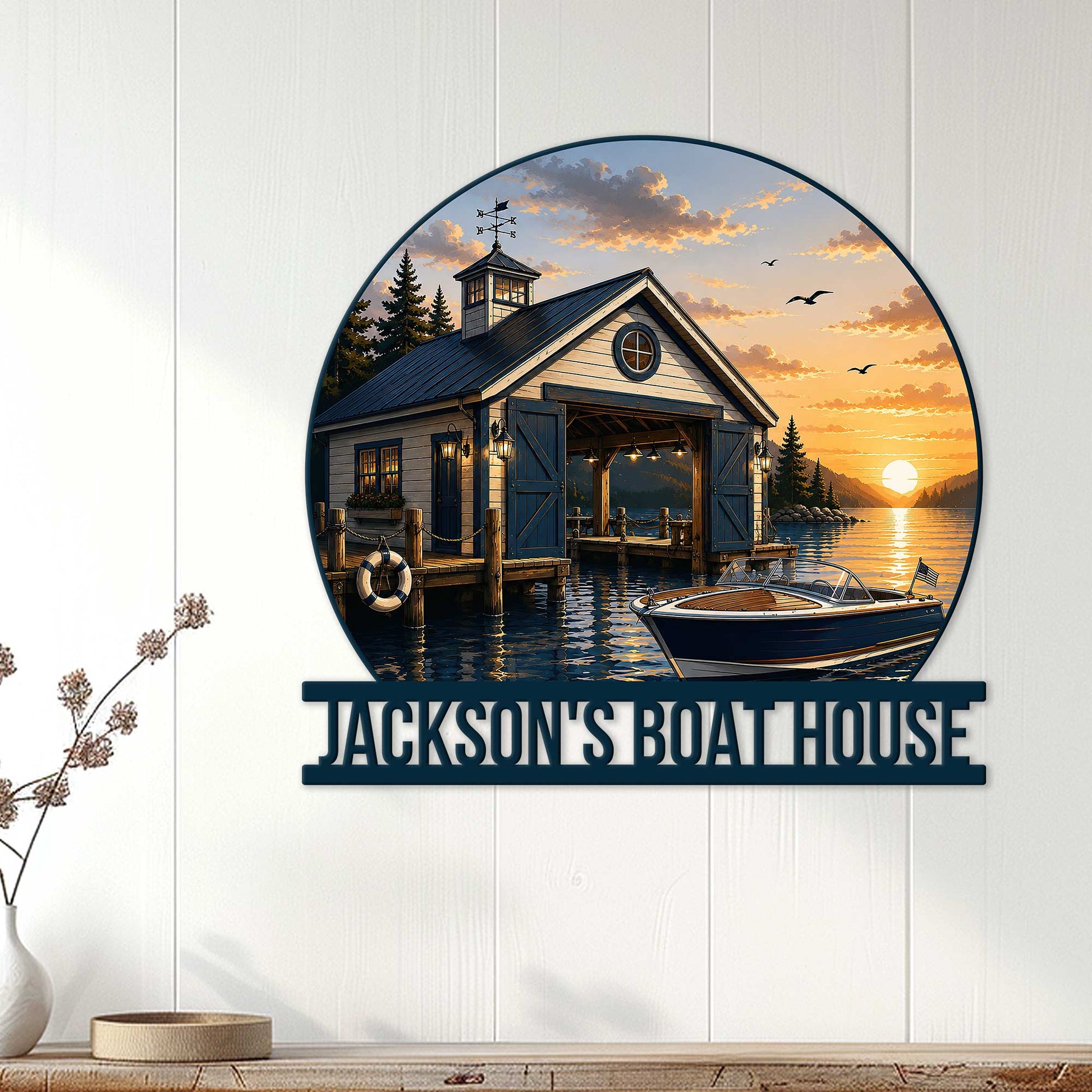 Boathouse metal sign displayed on a light wood wall above a console, featuring a sunset lake and boat scene