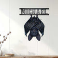 Gothic bat wall sign displayed on white paneled decor, creating a dramatic dark accent above a console