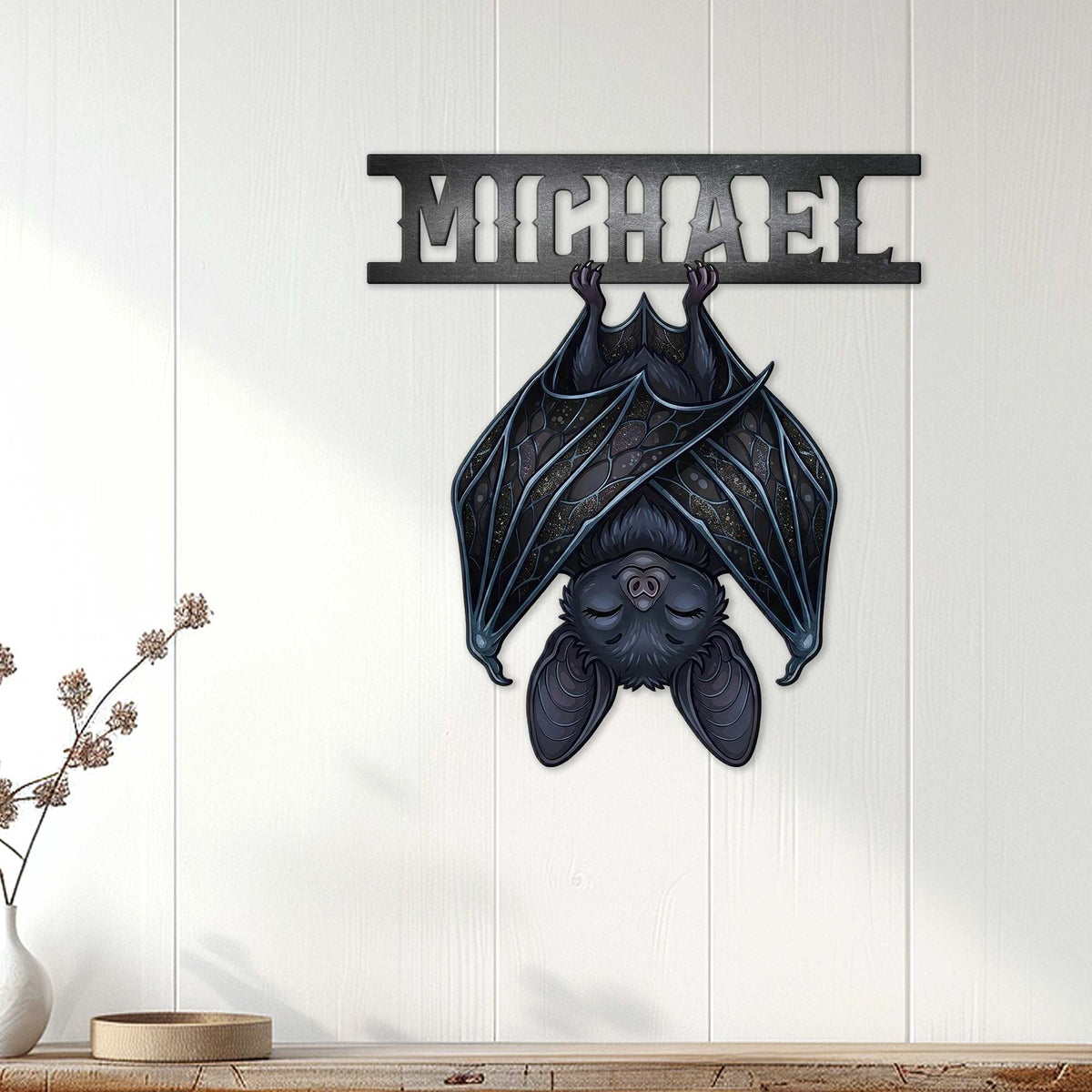 Gothic bat wall sign displayed on white paneled decor, creating a dramatic dark accent above a console