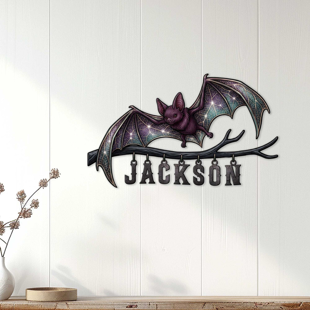 Bat wall decor displayed on a light wood-paneled wall above a console table