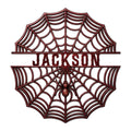 Decorative spider web metal sign featuring a centered spider and open web silhouette in a dark red finish