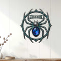 Ornate spider metal sign displayed on a white paneled wall as distinctive home decor