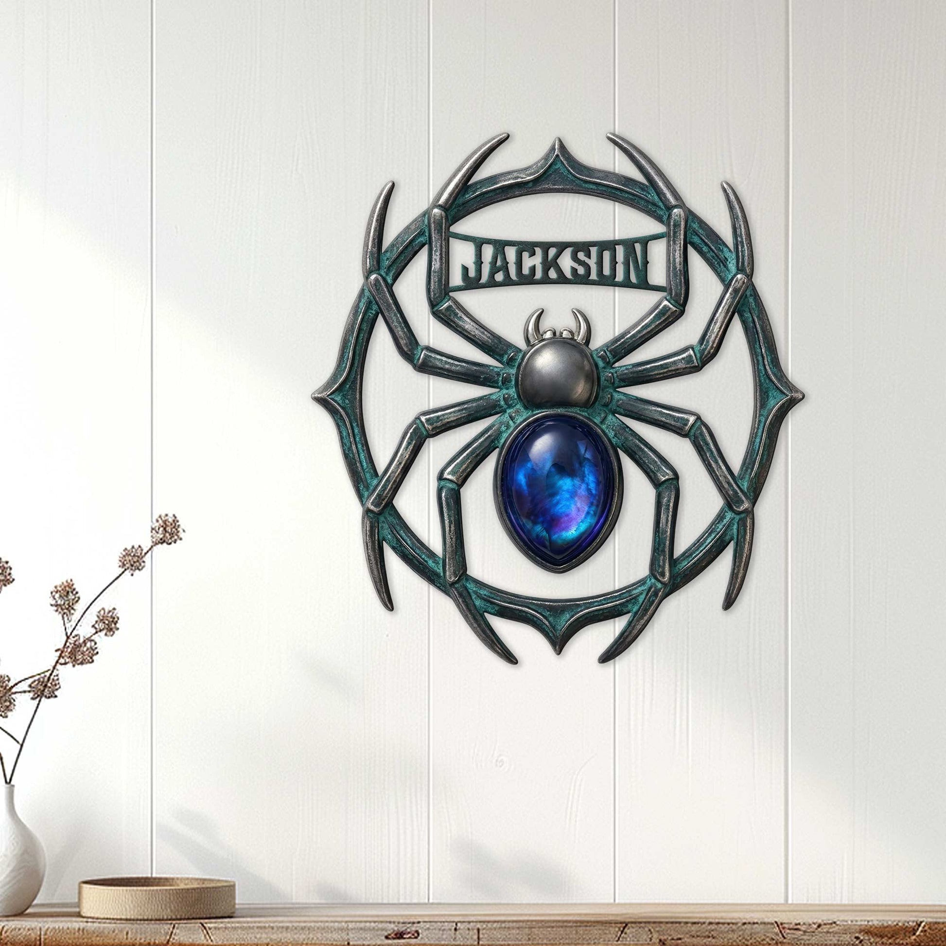 Ornate spider metal sign displayed on a white paneled wall as distinctive home decor