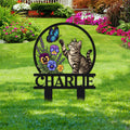 Tabby cat metal sign displayed in a flower garden with a butterfly and colorful floral artwork