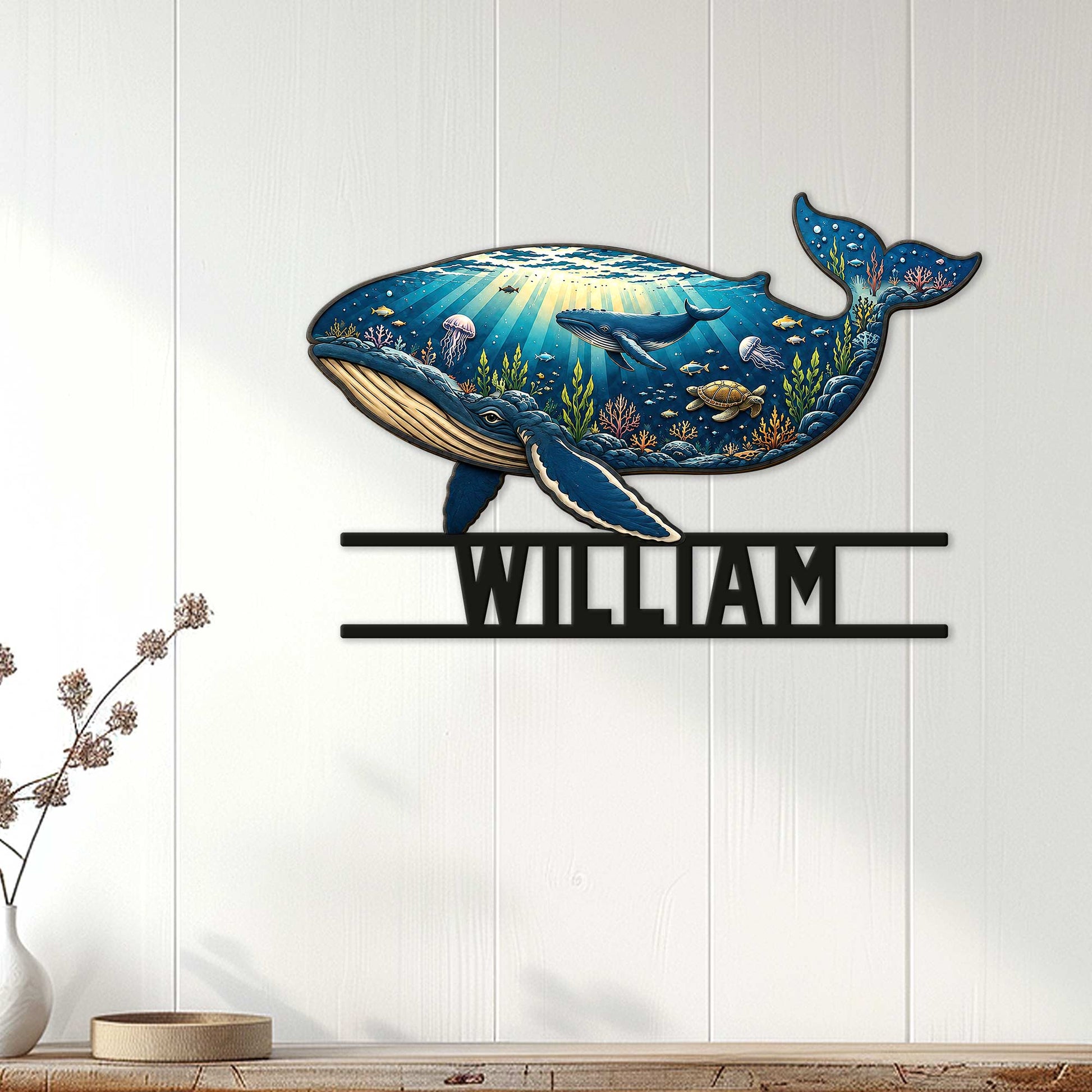 Whale-shaped ocean metal sign displayed as wall decor on a light wood-paneled interior wall