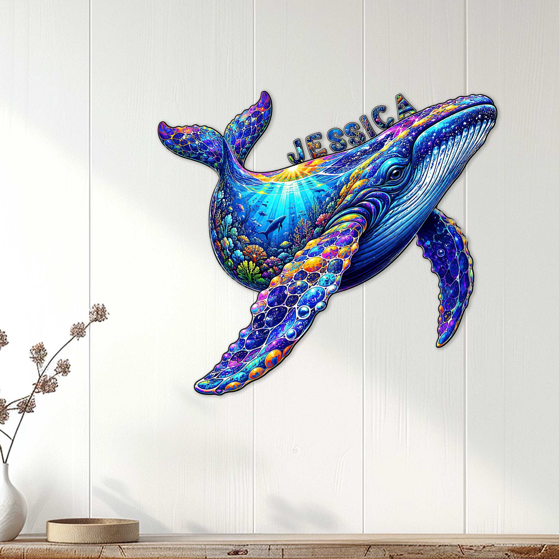 Colorful whale wall decor displayed on a light wood wall in a bright coastal-inspired room