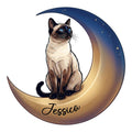 Siamese cat metal sign featuring a blue-eyed cat seated on a golden crescent moon under stars