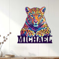 Colorful leopard wall sign displayed on a light wood-paneled wall in a modern home interior