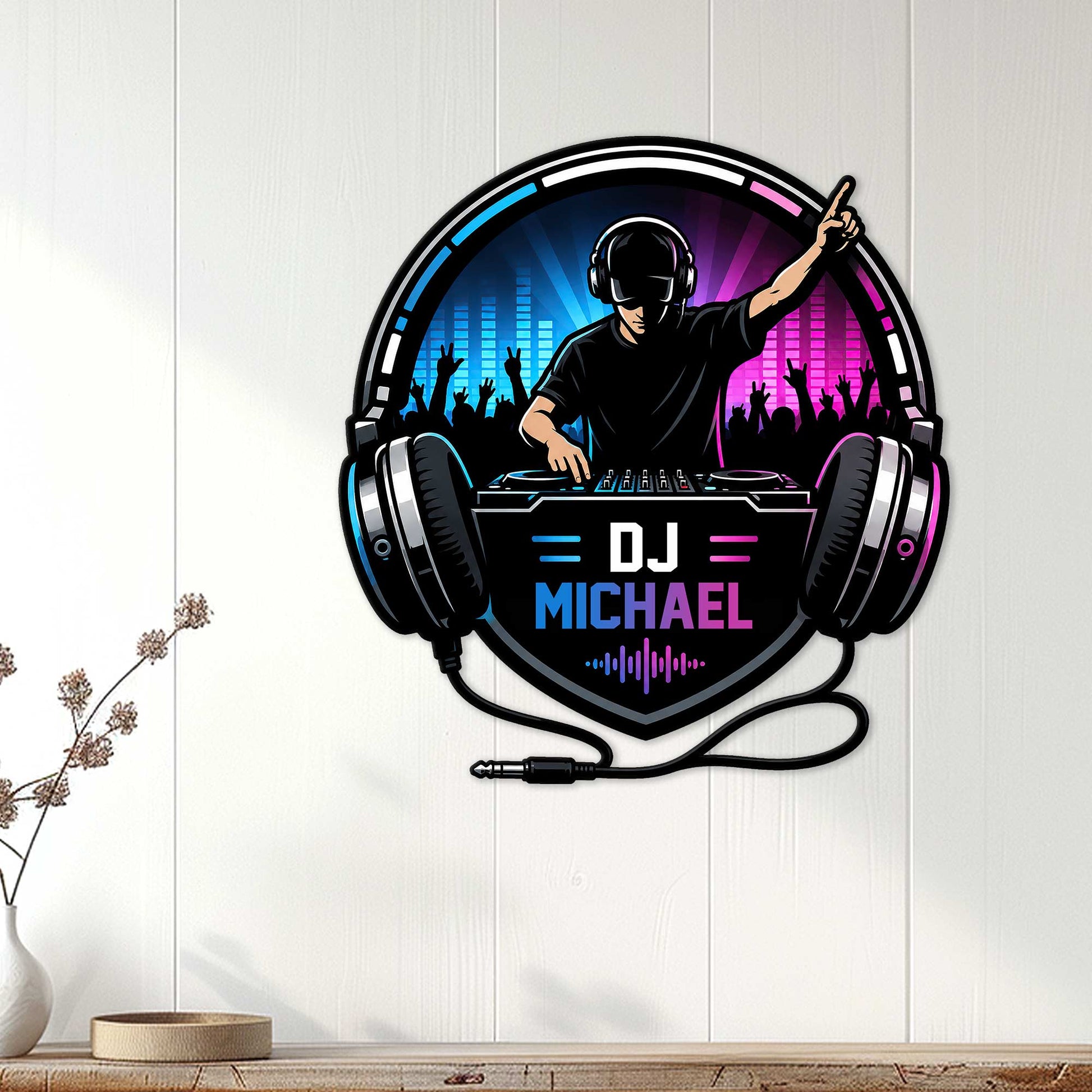 DJ wall sign displayed on a white paneled wall, featuring headphones, turntables, a concert crowd, and neon lighting