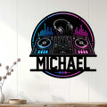 DJ wall sign displayed on a white paneled wall with colorful headphones, turntables, and audio controls