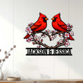 Cardinal wall decor displayed on a white wood wall above a console table