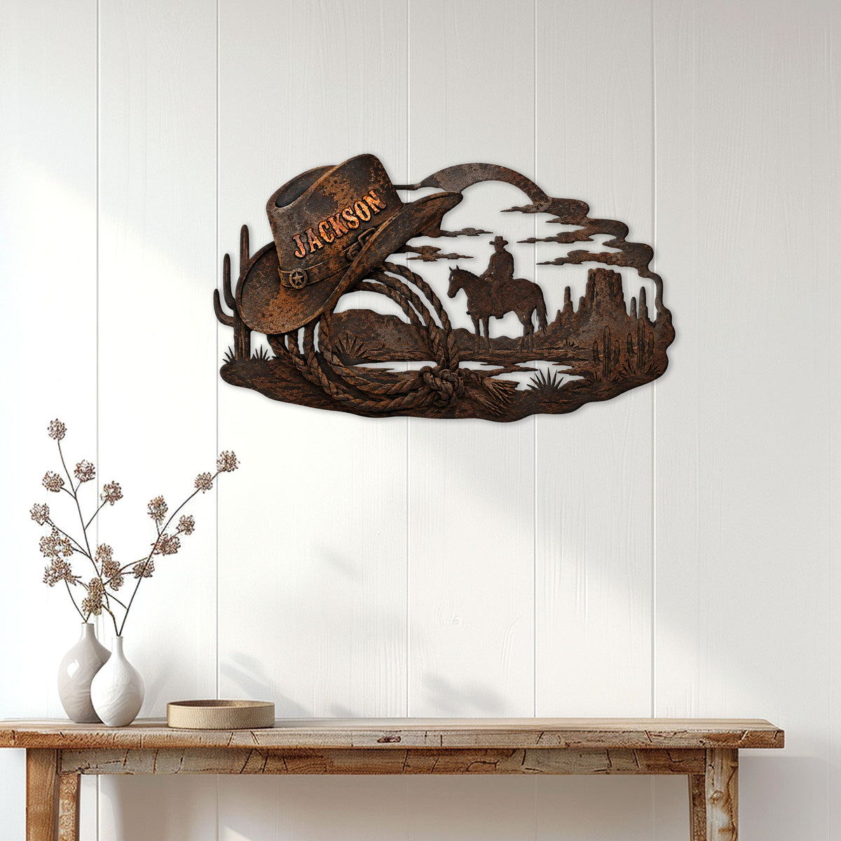 Cowboy metal wall sign displayed on a white paneled wall above a rustic console table