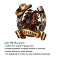 Cowboy cut metal sign featuring a western rider on horseback with a horseshoe border and scroll design