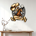 Western cowboy metal wall sign displayed above a rustic console table in a bright home interior