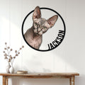Sphynx cat metal wall sign displayed above a console table in a bright home interior