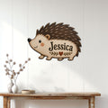 Hedgehog metal sign displayed as wall decor on white paneling above a rustic console table