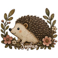 Detailed hedgehog metal sign framed by leafy branches and soft pink flowers in a vintage woodland style
