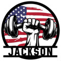 Patriotic weightlifting metal sign featuring a raised fist gripping a dumbbell over an American flag