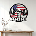 Patriotic dumbbell and raised fist metal sign displayed on a bright paneled wall