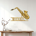 Golden saxophone wall sign displayed on a white paneled wall above a console table