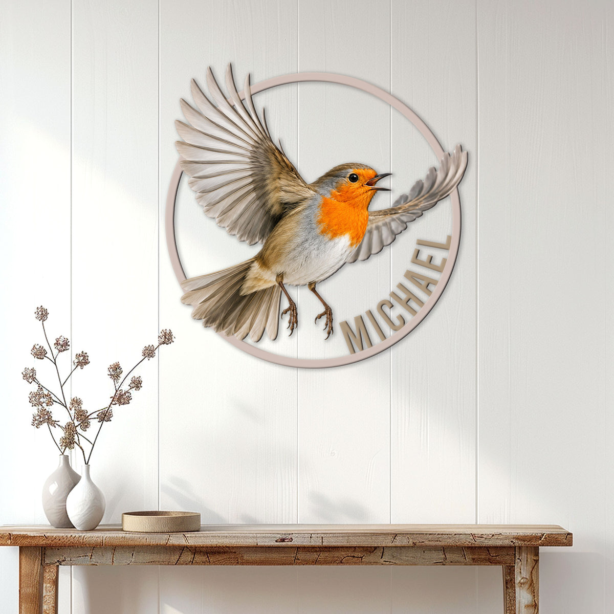 Robin metal wall sign displayed on a white paneled wall above a rustic console table