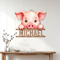 Watercolor pig metal wall sign displayed on a light paneled wall above a console table