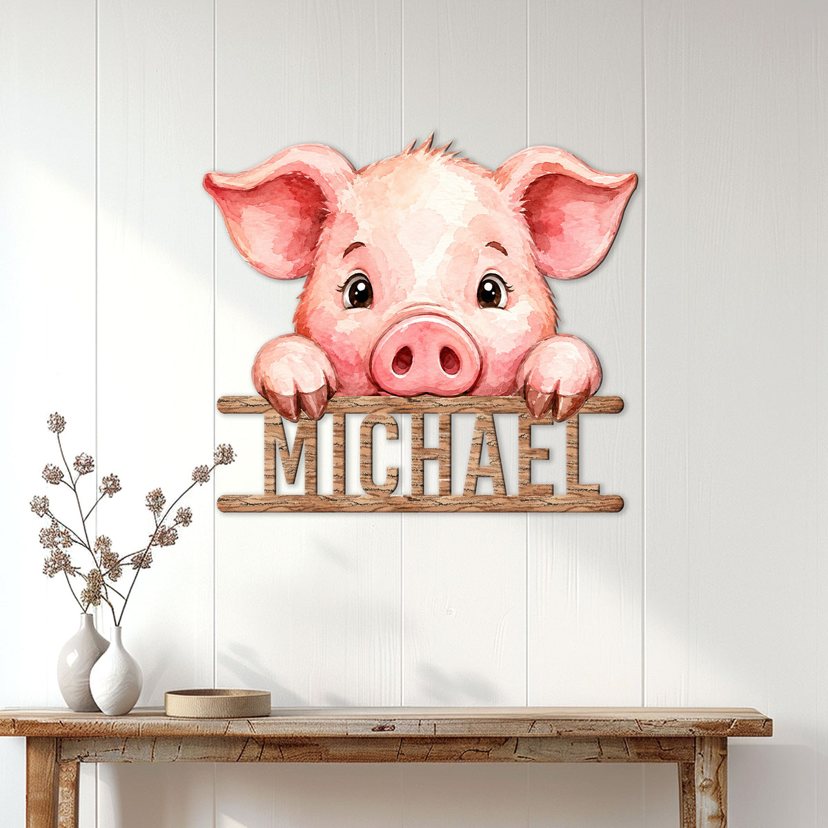Watercolor pig metal wall sign displayed on a light paneled wall above a console table