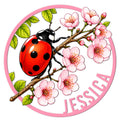 Custom ladybug metal sign featuring a bright red ladybug on a flowering branch with pink blossoms and green leaves