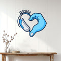 Sign language heart hands metal wall sign displayed on a white paneled wall