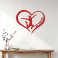Red baton twirling heart metal sign displayed as wall decor above a console table